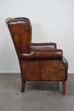 Large Sheepskin Leather Wingback Armchair With A Fixed Seat Cushion And A Stunning Patina -Chairly Shop 2df5fc88 b674 440a 97f4 3361eea05208