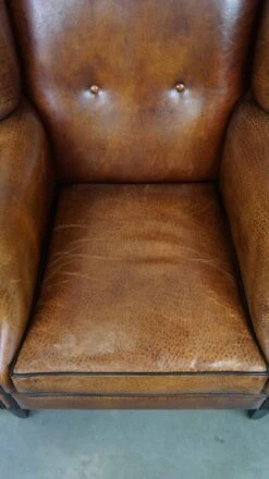 Beautiful Sheepskin Leather Wingback Armchair, With Nails And Black Piping -Chairly Shop 3d29ce89 496e 41d2 b3b3 1378d36a88f2