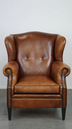 Beautiful Sheepskin Leather Wingback Armchair, With Nails And Black Piping -Chairly Shop 3d7d6186 4ee9 4398 ad9c 2b0c9b3a4150