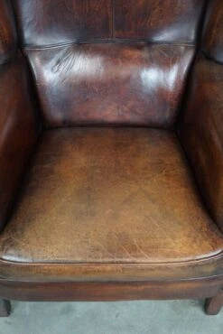 Large Sheepskin Leather Wingback Armchair With A Fixed Seat Cushion And A Stunning Patina -Chairly Shop ae786a2f 7f2e 42b3 835f e093bc8f6d4b
