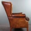 Very Rugged Wingback Armchair Made Of Cognac-colored Sheep Leather Finished With Decorative Nail Hea -Chairly Shop ea931773 967b 4a96 9209 af5207de7b91