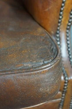 Very Rugged Wingback Armchair Made Of Cognac-colored Sheep Leather Finished With Decorative Nail Hea 16 Very Rugged Wingback Armchair Made Of Cognac-colored Sheep Leather Finished With Decorative Nail Hea -Chairly Shop fd8261c8 ecfd 441b aff6 ec463598c1b0